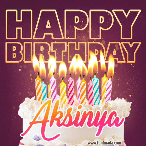 A colorful birthday cake topped with lit candles, with the words 'Happy Birthday Aksinya' in bold glowing letters on a burgundy background. Animated flames add a festive touch.