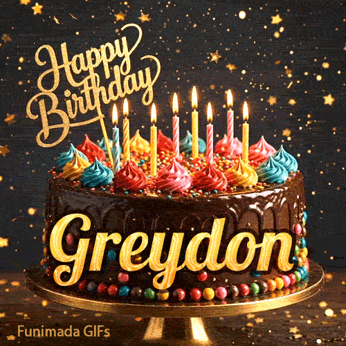 Close-up of a decorative chocolate cake with a gold Happy Birthday topper and warm glowing candle flames, made for Greydon.