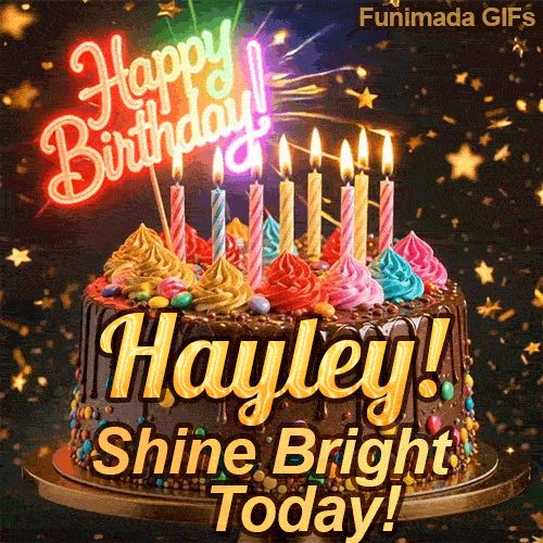 Close-up of a decorative chocolate cake with a glowing neon Happy Birthday sign and warm candle flames, made for Hayley.