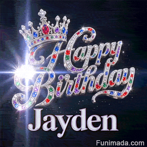 Close-up of a silver crown with emeralds, rubies, and sapphires resting on crystal-encrusted Happy Birthday text.Jayden