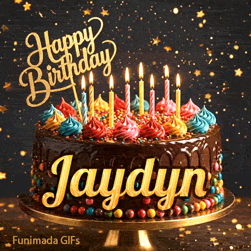 Yellow script spelling the name Jaydyn on a classic chocolate cake with a dark glaze under warm candlelight.