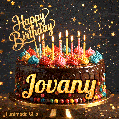 A chocolate drip birthday cake on a stand with colorful frosting and lit candles, featuring the name Jovany in glowing yellow letters.