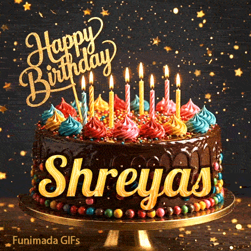 Burning birthday candles on top of a chocolate drip cake decorated with colorful icing dollops and sprinkles, personalized for Shreyas.