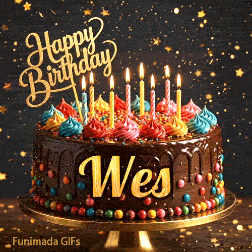 Burning birthday candles on top of a chocolate drip cake decorated with colorful icing dollops and sprinkles for Wes.
