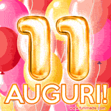 Bouquet animato di palloncini multicolori che emergono da una scatola regalo, con il numero 11 e la scritta 'Tanti Auguri!' su uno sfondo pieno di coriandoli.