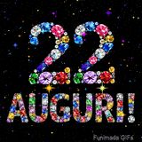 Il numero 22 e la scritta Auguri creati con gioielli brillanti di diverse tonalità su un fondo nero animato da piccole scintille di luce.