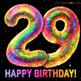 Shiny number 29 birthday celebration balloons with an iridescent glow and glitter on a black background with twinkling stars.