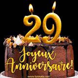 GIF animé pour un 29e anniversaire avec une élégante gâteau au chocolat, des bougies dorées formant le chiffre 29 et le texte 'Joyeux Anniversaire!' en écriture dorée.