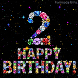 An animated image on a dark background showing the digit 2 and Happy Birthday text formed by multicolored diamonds surrounded by bright shining sparks.
