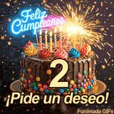 Tarta festiva con el dígito 2 en el centro, iluminada por una luz brillante. Estrellitas doradas caen sobre el mensaje ¡Pide un deseo! y Feliz Cumpleaños.