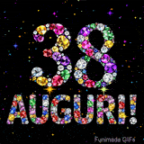 Il numero 38 e la scritta Auguri creati con gioielli brillanti di diverse tonalità su un fondo nero animato da piccole scintille di luce.