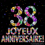 Le chiffre 38 et le lettrage Joyeux Anniversaire réalisés en joyaux éclatants de diverses couleurs sur une toile noire avec des étincelles.