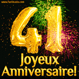 GIF animé pour un 41e anniversaire avec des ballons dorés en forme de 41, des feux d'artifice colorés et le texte 'Joyeux Anniversaire!' sur un fond noir festif.