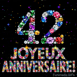 Le chiffre 42 et l'inscription Joyeux Anniversaire dessinés par des joyaux brillants multicolores, entourés de petites étincelles sur fond sombre.