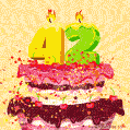 A festive, animated image of a birthday cake with lit candles forming '42'. Confetti and cherries adorn the tiered cake, for a 42nd birthday.