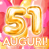 Bouquet animato di palloncini multicolori che emergono da una scatola regalo, con il numero 51 e la scritta 'Tanti Auguri!' su uno sfondo pieno di coriandoli.