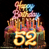 Spinning colorful birthday cake GIF featuring vibrant rainbow drip frosting, lit candles, and glowing number 52 for 52nd birthday.