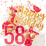 A celebratory 58th birthday GIF, featuring a white creme cake, decorated with red roses, strawberry slices, and golden candies. The decorative text in gold reads 'Happy Birthday'. Red and yellow star-shaped confetti are scattered over the image.