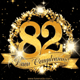 Il numero 82 è circondato da un anello dorato brillante, accompagnato da un nastro elegante con la scritta 'Buon Compleanno!' su uno sfondo scuro.