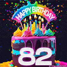 Chocolate cake with cyan layers, pink dressing and a big number 82 adorned with vibrant multicolored frosting, lit candles, and a rainbow topper with text that says 'Happy Birthday'. Animated colorful confetti move behind the cake.