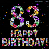 The number 83 alongside the words Happy Birthday, crafted from glittering multi-colored gemstones, glowing against a pitch-black space with tiny color sparks.