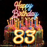 Spinning 83rd birthday cake GIF decorated with rainbow frosting, burning candles, and large glowing yellow number 83.