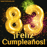 GIF animado con globos dorados en forma del número 83, acompañado de fuegos artificiales de colores y la frase '¡Feliz cumpleaños!' en letras vibrantes.