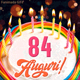Un'animazione celebrativa di una torta di compleanno per i 84 anni, Le fiamme delle candeline tremolano e delle scintille brillano intorno, creando un'atmosfera festosa e magica.