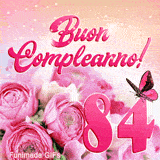 Buon compleanno 84 anni in questa GIF festosa con rose rosa, numero rosa e esplosioni di luce stellata animate nello sfondo.