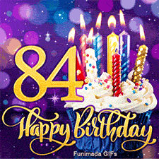 The digit 84 in gold beside a blue-wrapped cupcake with burning colorful candles. Golden Happy Birthday lettering on a blurry purple bokeh backdrop.