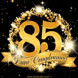 Il numero 85 è circondato da un anello dorato brillante, accompagnato da un nastro elegante con la scritta 'Buon Compleanno!' su uno sfondo scuro.