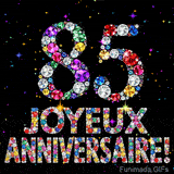 Sur un fond sombre, le chiffre 85 et Joyeux Anniversaire sont formés par des diamants multicolores, accompagnés de petites étoiles scintillantes.