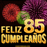 GIF animado con el número 85 en dorado, rodeado de fuegos artificiales rojos, verdes y morados, con el mensaje 'Feliz cumpleaños' en letras doradas.