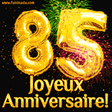 GIF animé pour un 85e anniversaire avec des ballons dorés en forme de 85, des feux d'artifice colorés et le texte 'Joyeux Anniversaire!' sur un fond noir festif.