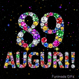 Il numero 89 e la scritta Auguri formati da gemme colorate e scintillanti su uno sfondo nero animato da piccole stelle luminose.