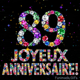 Le chiffre 89 et les mots Joyeux Anniversaire formés de diamants colorés étincelants sur fond noir avec de petites étoiles scintillantes animées.