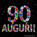 Il numero 90 e l'espressione Auguri disegnati da gioielli brillanti multicolori, circondati da piccole scintille su uno sfondo scuro.