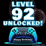 Animated GIF for a 92 birthday. The text 'Level 92 Unlocked!' and 'Happy Birthday!' are displayed over a blue video game controller with exploding fireworks in the background.