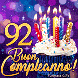 GIF di compleanno 92 anni con il numero 92 in oro brillante, una torta magica e luci colorate.