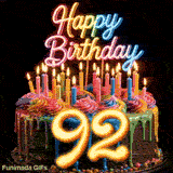 Rotating 92nd birthday cake GIF featuring colorful drip icing, lit candles, neon topper, and glowing golden number 92.