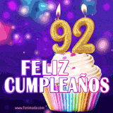 GIF animado de un cupcake decorado con confites, dos velas doradas encendidas formando el número 92, sobre un fondo púrpura brillante con destellos.