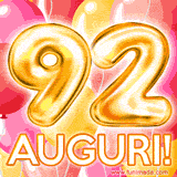 Bouquet animato di palloncini multicolori che emergono da una scatola regalo, con il numero 92 e la scritta 'Tanti Auguri!' su uno sfondo pieno di coriandoli.