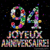 Le chiffre 94 et le lettrage Joyeux Anniversaire réalisés en joyaux éclatants de diverses couleurs sur une toile noire avec des étincelles.