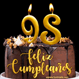 GIF de un pastel de chocolate con decoración de crema, velas doradas con el número 98 encendido, y un fondo negro elegante y cálido.