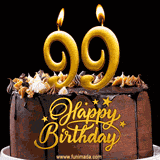 99th birthday GIF featuring a chocolate birthday cake displaying 'Happy Birthday' lettering in gold, and two lit gold candles shaped as '99' lighting up the top.