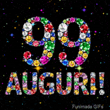 Animazione con il numero 99 e la parola Auguri creati da pietre preziose colorate, con un effetto scintillante su sfondo nero.