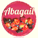 Beautifully decorated red velvet berry birthday cake with vibrant fruits and a glowing 'Abagail' name, adding a touch of sweetness and sparkle.