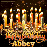 A glowing personalized birthday GIF with name Abbey featuring lit candles with intricate designs, warm lighting, and the text 'Happy Birthday' in an elegant font.