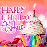 A vibrant birthday GIF featuring a rainbow-colored cupcake topped with white frosting, sprinkles, and a lit candle. The text reads 'Happy Birthday Abbie' in bold pink and violet letters with white outline.