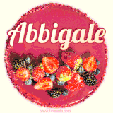 Beautifully decorated red velvet berry birthday cake with vibrant fruits and a glowing 'Abbigale' name, adding a touch of sweetness and sparkle.